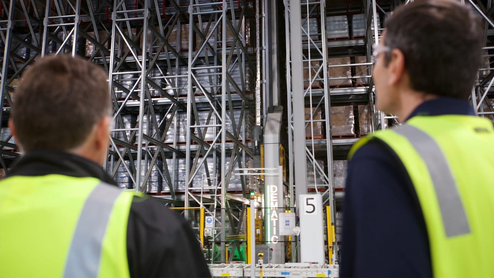 Two men monitoring ASRS in warehouse 